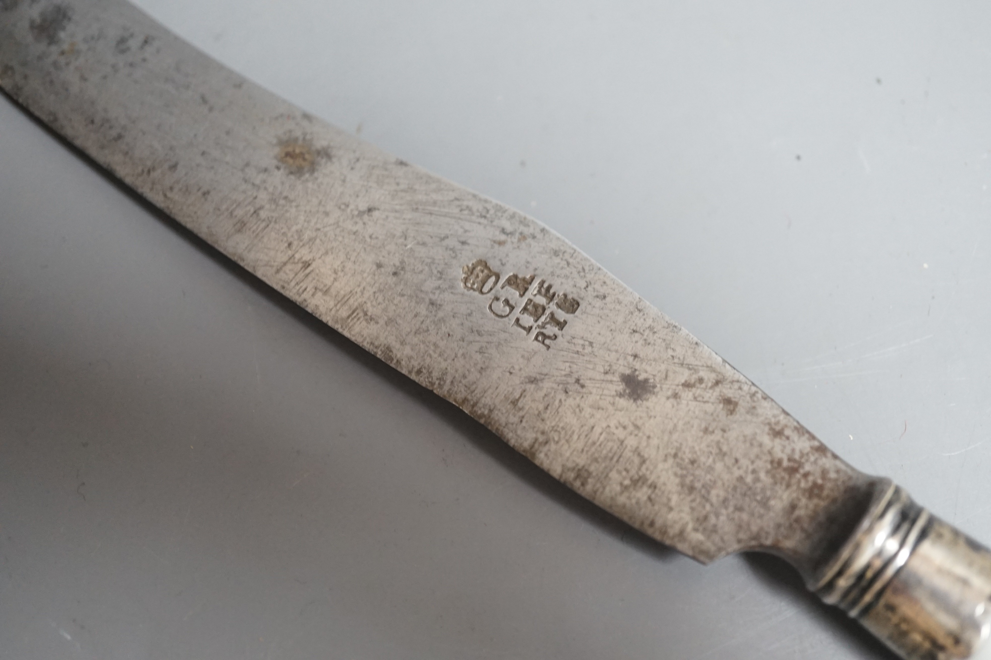 A Chelsea blanc de chine knife handle moulded with entwined branches and flowerheads, with silver ferule, incised triangle period